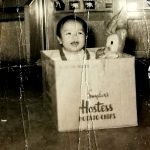 baby in a makeshift playpen a chip box